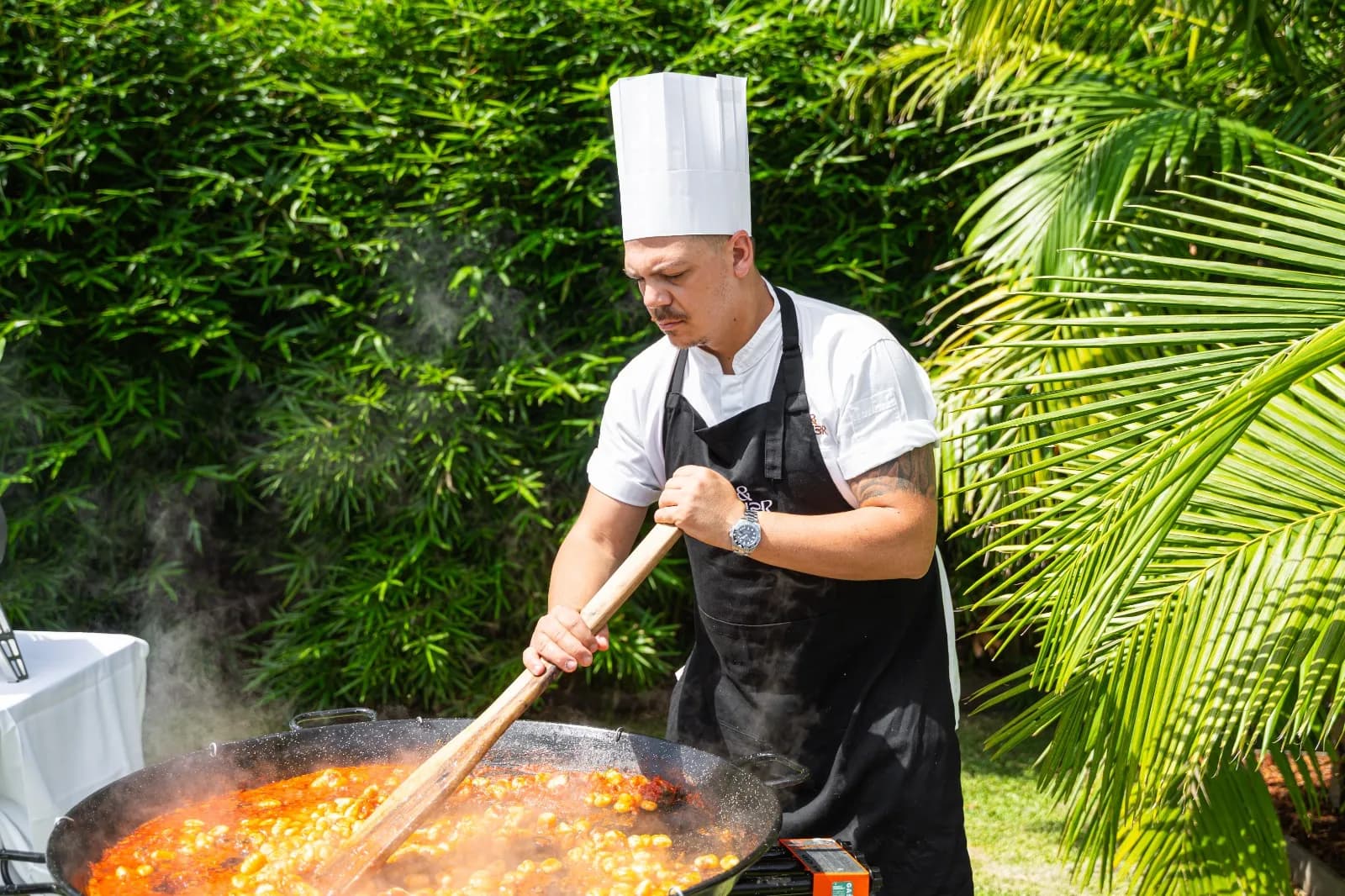 Chef Gabriele Franco cooking outdoors at a catering event