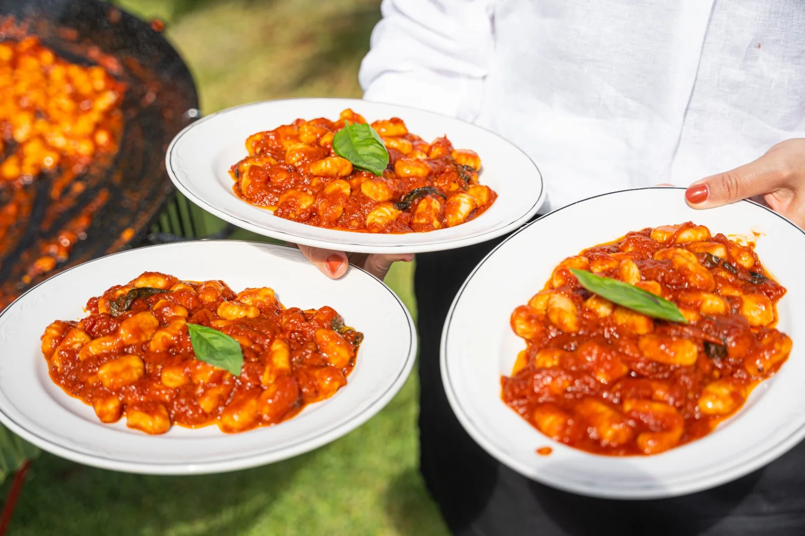 Plates of gnocchi al pomodoro served at a Table & Together event
