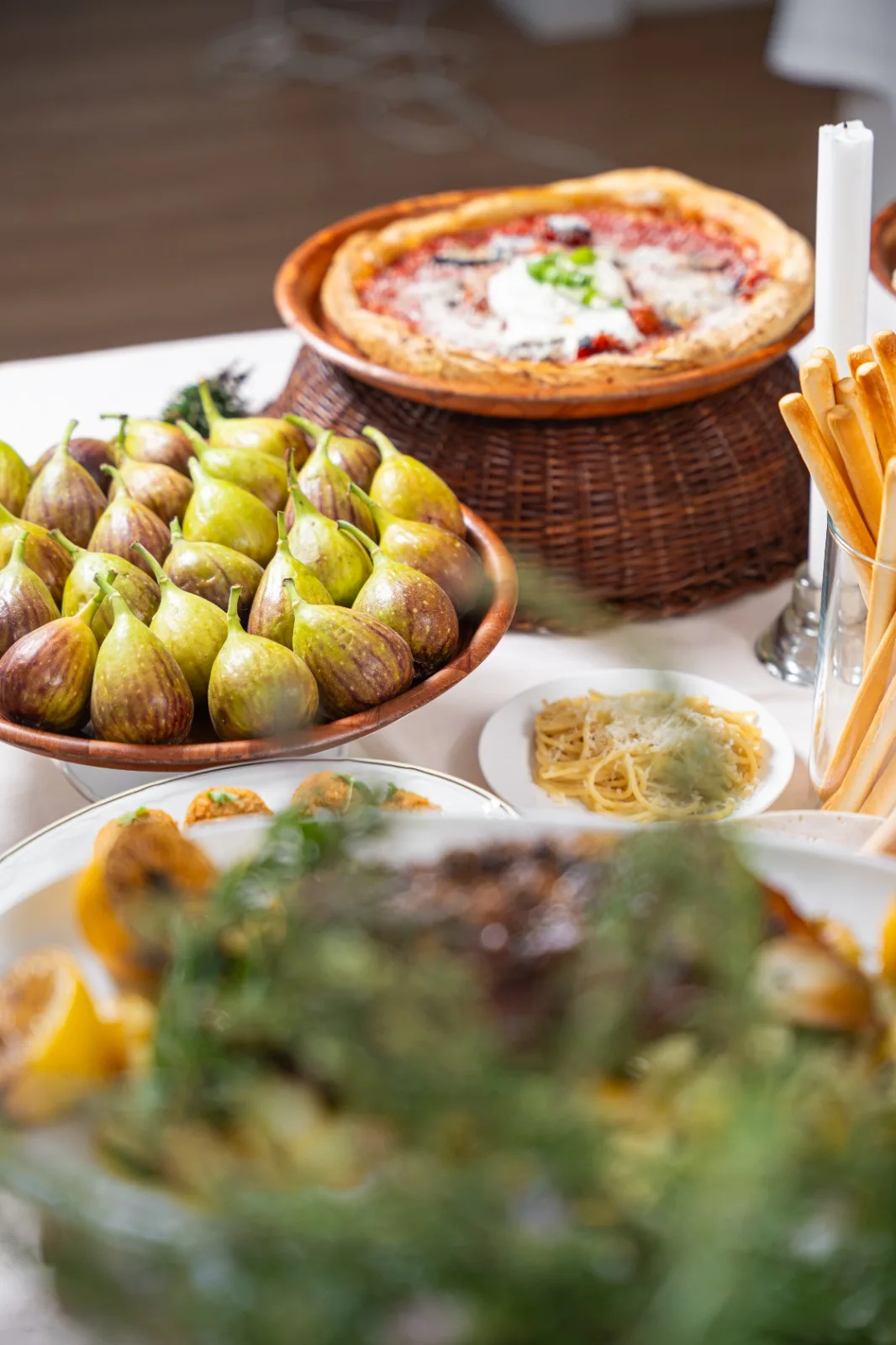 Italian grazing table with figs, pizza and pasta
