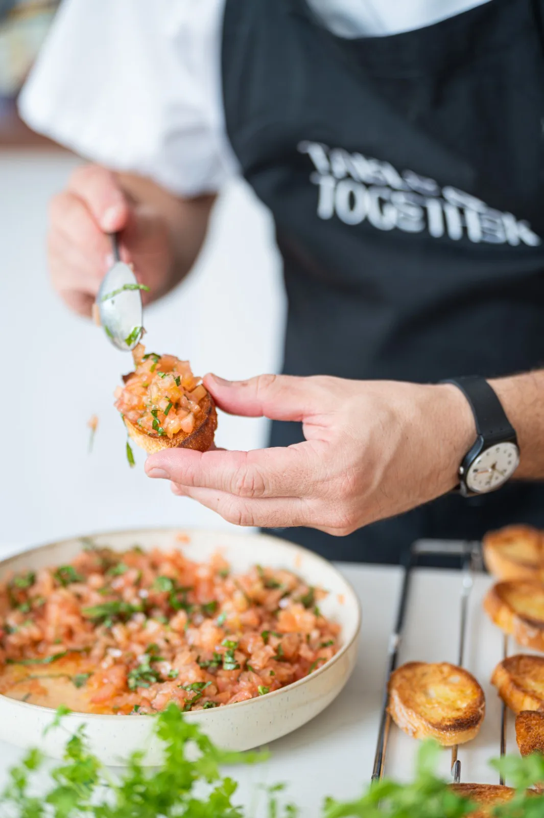 Chef plating bruschetta al pomodoro